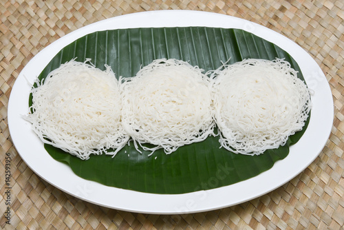 Noolappam/Idiyappam/rice noodles, a popular traditional steam cooked Kerala breakfast dish with hot and spicy egg roast curry on a houseboat, Alleppey, India. South Indian food. noolputtu Sri lankan photo