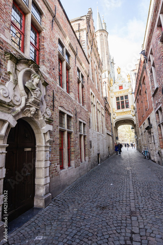 Architecture of narrow bicked street of Brugge town in Begium © photo_superteam