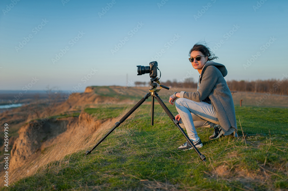 A tripod with a camera shoots the landscape