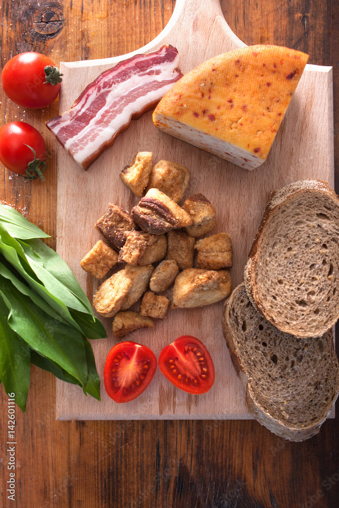 pork greaves cheease and bacon on wooden background pork greaves cheease and bacon on wooden background