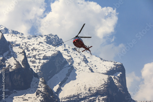 Red helicopter and Himalaya Annapurna mountain, Nepal