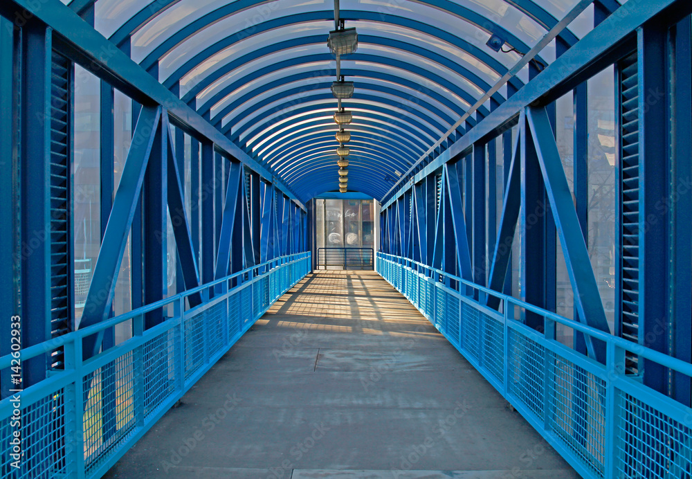 Blue overhead pedestrian bridge in the city Blue overhead pedestrian bridge in the city