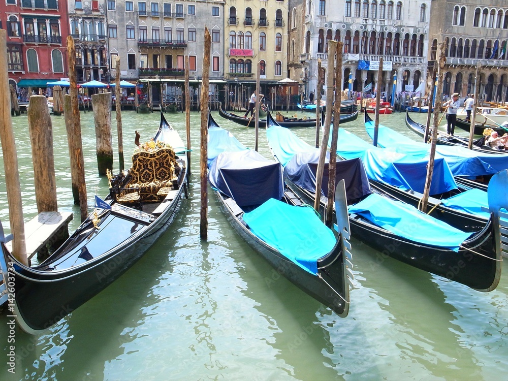 VENICE, ITALY - MAY 25, 2015 : many gondola parked in front of the canals waiting for a tourism ride.