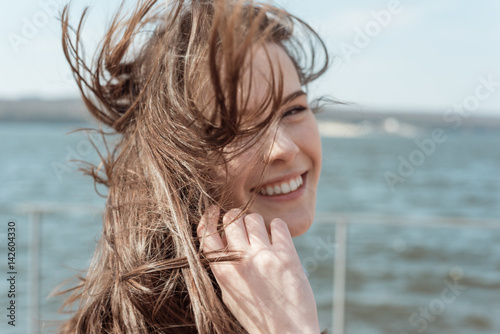 Spring or summer portrait of a beautiful young woman smiling happy student outdoor