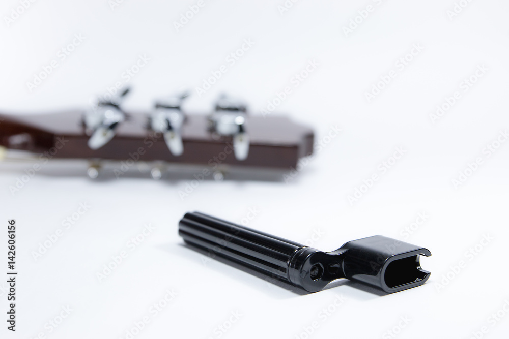 String winder and guitar heads placed on a white background. String winder and guitar heads placed on a white background.