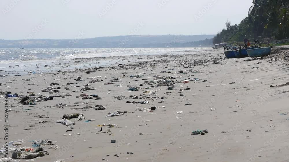 Pan shot of plastic garbage and trash on the beach. static shot. Horrible ecological disaster on shoreline Pan shot of plastic garbage and trash on the beach. static shot. Horrible ecological disaster on shoreline