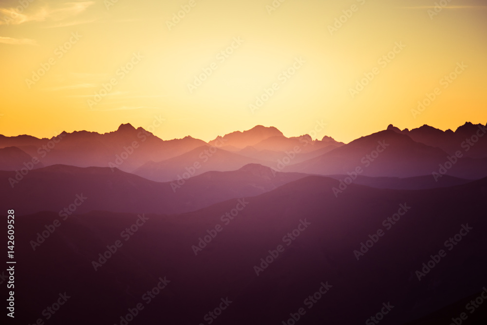 Obraz premium A beautiful, colorful, abstract mountain landscape in a mystic purple and orange tonality. Decorative, artistic look.