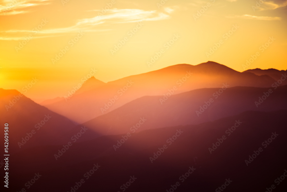 A beautiful, colorful, abstract mountain landscape in a mystic purple and orange tonality. Decorative, artistic look.