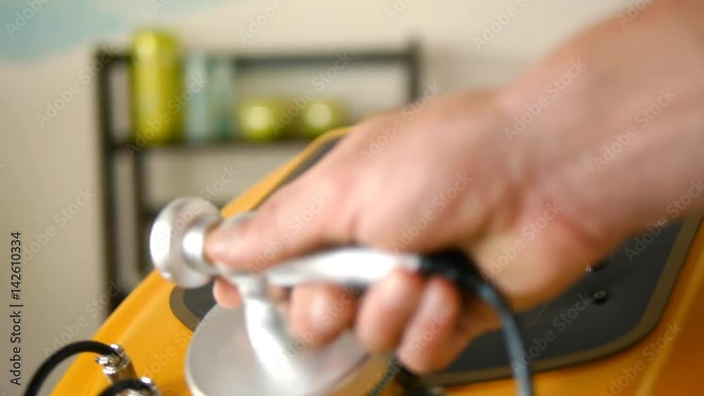 Skin care in beauty salon. Nurse switchs on the apparatus of lifting anti-cellulite treatment in spa. Close up shot Skin care in beauty salon. Nurse switchs on the apparatus of lifting anti-cellulite treatment in spa. Close up shot