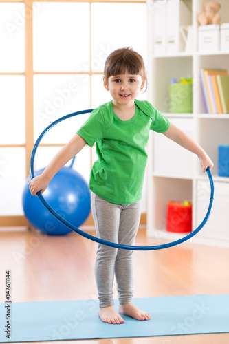 kid girl doing gymnastic wi...