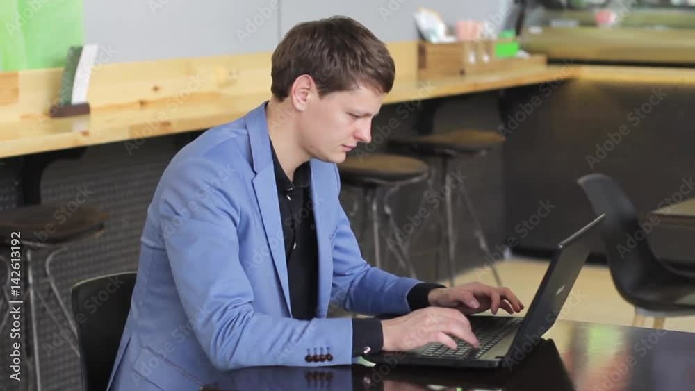 young businessman working on computer in cafe young businessman working on computer in cafe
