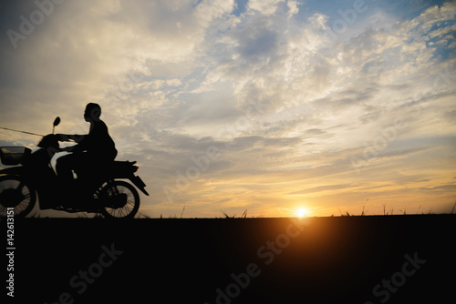 Silhouette of a man biker motorcycle in the sunset