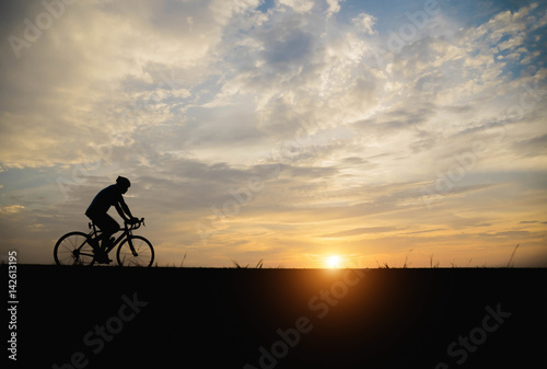 Silhouette of a man biker in the sunset