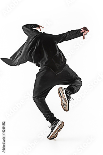 The silhouette of one hip hop male break dancer dancing on white background