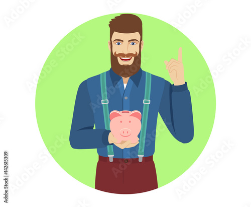 Hipster holding a piggy bank and pointing up