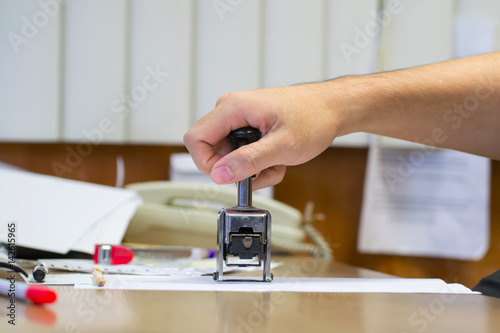 Office paper document stamp in business human hand