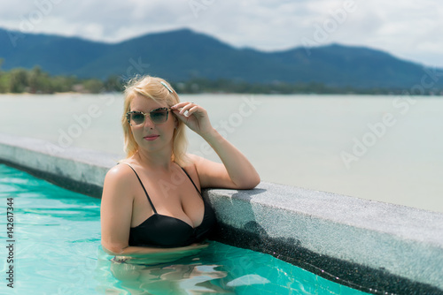Woman relaxing in pool in resort