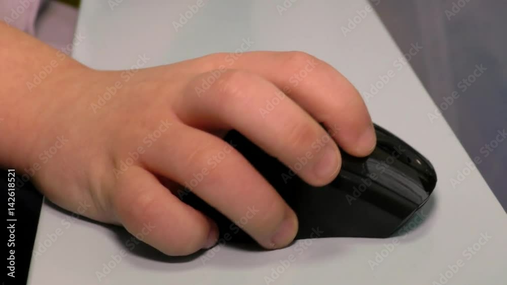 Computer mouse in child's hand. The early development of children and teaching them computer technology. Craving for to the Internet and social networks are brought up from childhood. Computer mouse in child's hand. The early development of children and teaching them computer technology. Craving for to the Internet and social networks are brought up from childhood.