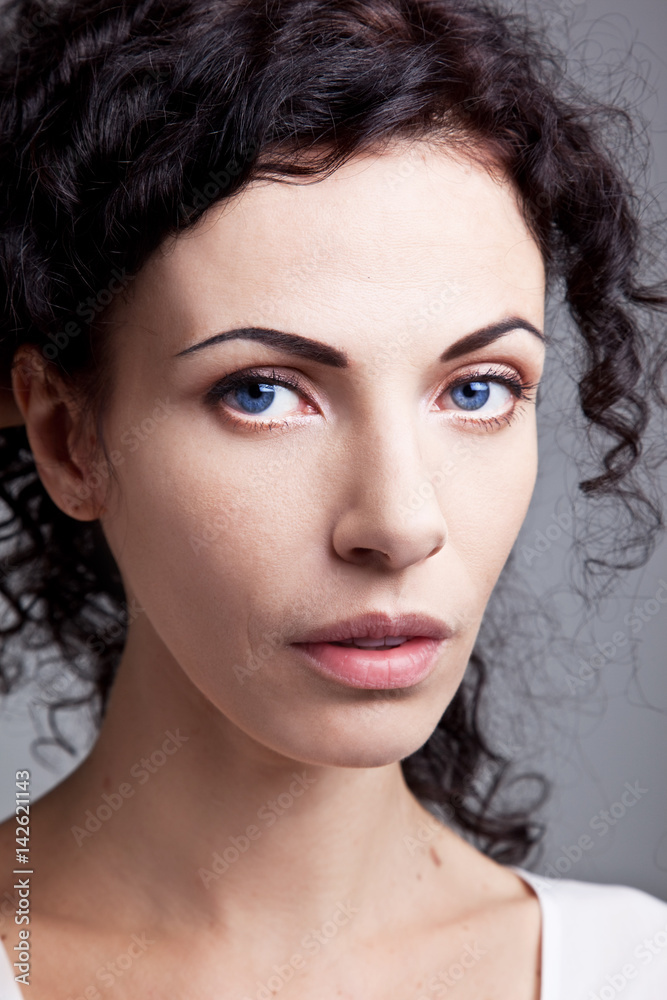 Naklejka premium Curly noble blue-eyed woman 