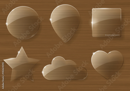 A set of glass icons or geometric shapes on a wooden texture background. Vector graphics with the effect of transparency.