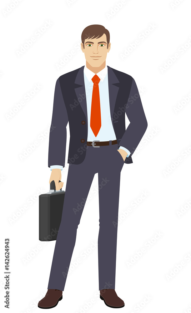 Businessman with briefcase standing with hand in pocket