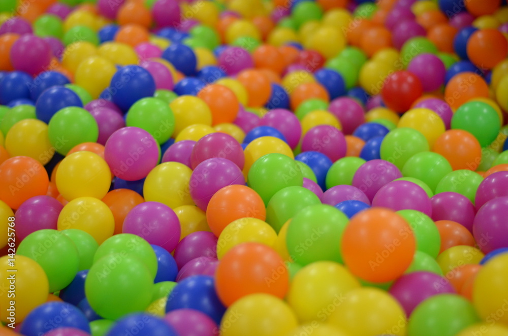 The colored balls in the children's playroom. Holiday, children's party, a games room, a box filled with small colored balls, playing in ball land, ball land pattern wallpaper