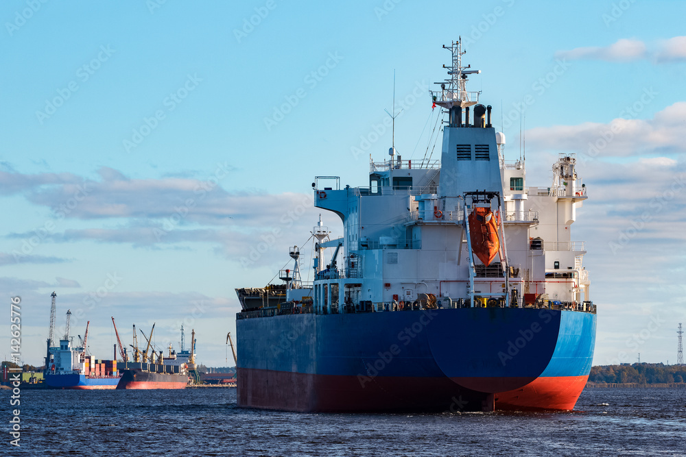 Fototapeta premium Blue cargo ship entering the port of Riga, Europe