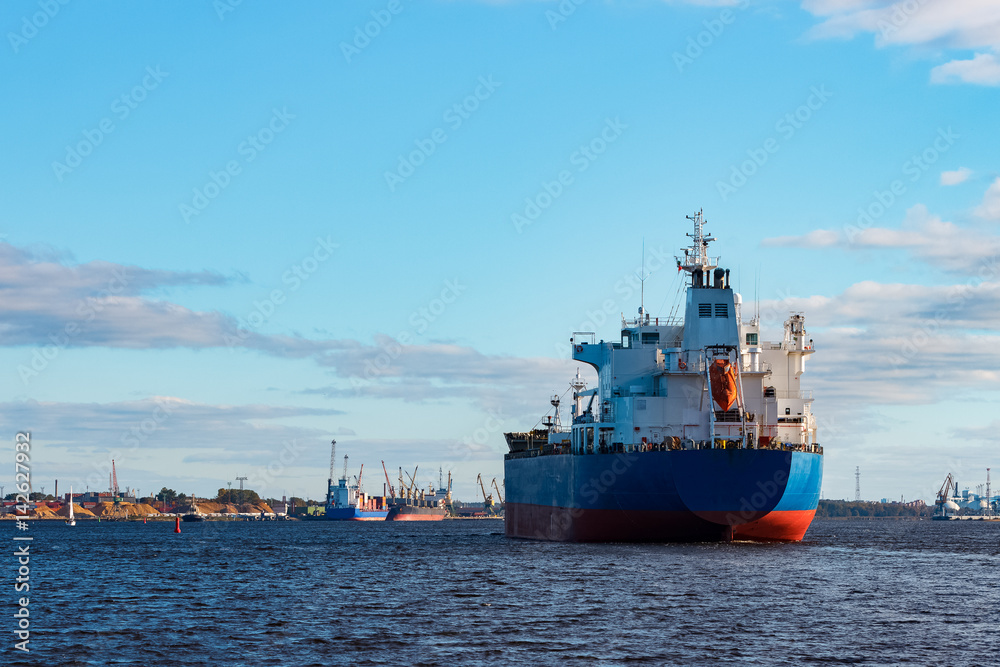 Blue cargo ship entering the port of Riga, Europe