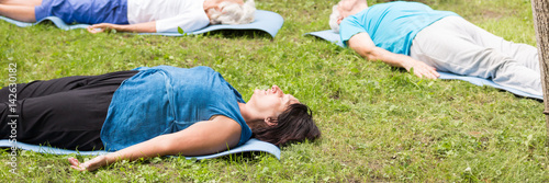 Seniors lying on the grass in the park