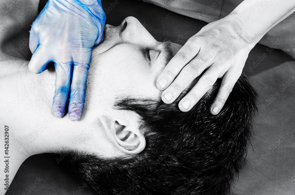 Physiotherapist is doing intraoral technique of massage masseter muscle