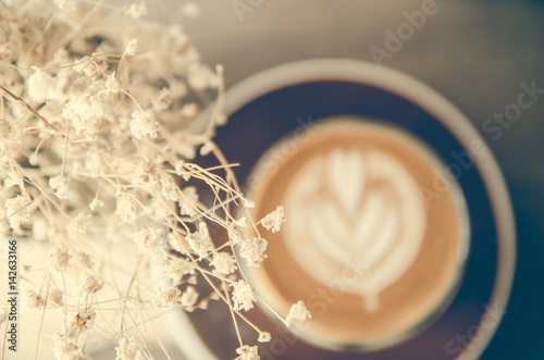 dry flower in steel can decoration in coffee shop on wood table photo