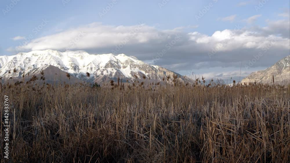Clouds moving thought the sky over snow capped mountains Clouds moving thought the sky over snow capped mountains