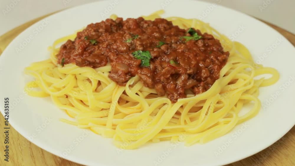Freshly cooked spaghetti covered with tomato sauce, rotating Freshly cooked spaghetti covered with tomato sauce, rotating