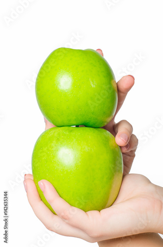 in beautiful hands a two green apple , Isolated on white background