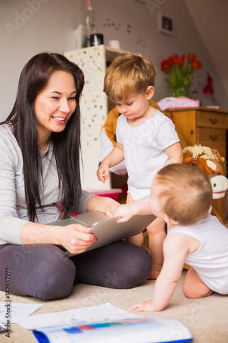 mother and children looking at laptop