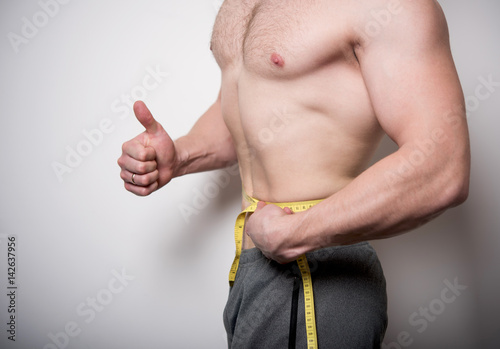 man measures the abdomen