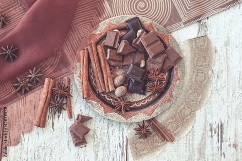 chocolate and spices on decorated copper plate