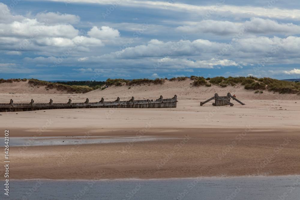 a sandy beach with a cloudy sky and sea a sandy beach with a cloudy sky and sea