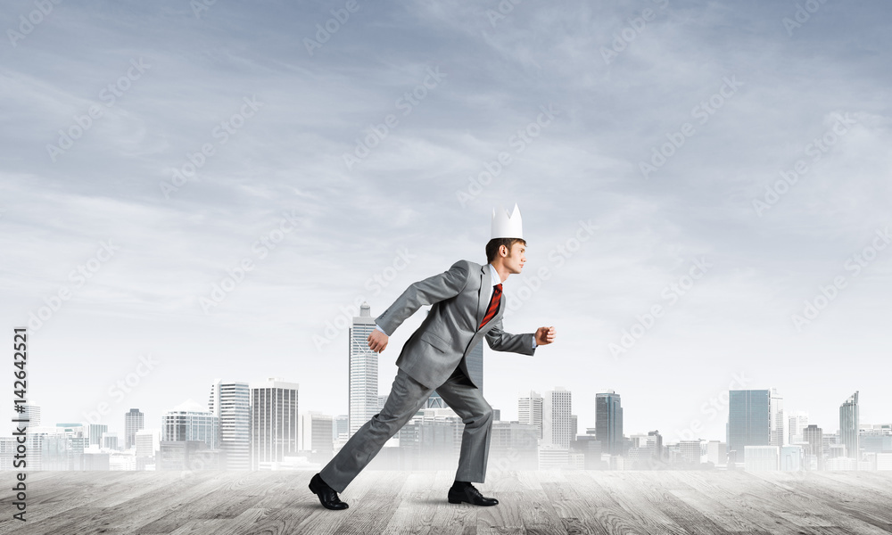 King businessman in elegant suit running and modern cityscape at background King businessman in elegant suit running and modern cityscape at background