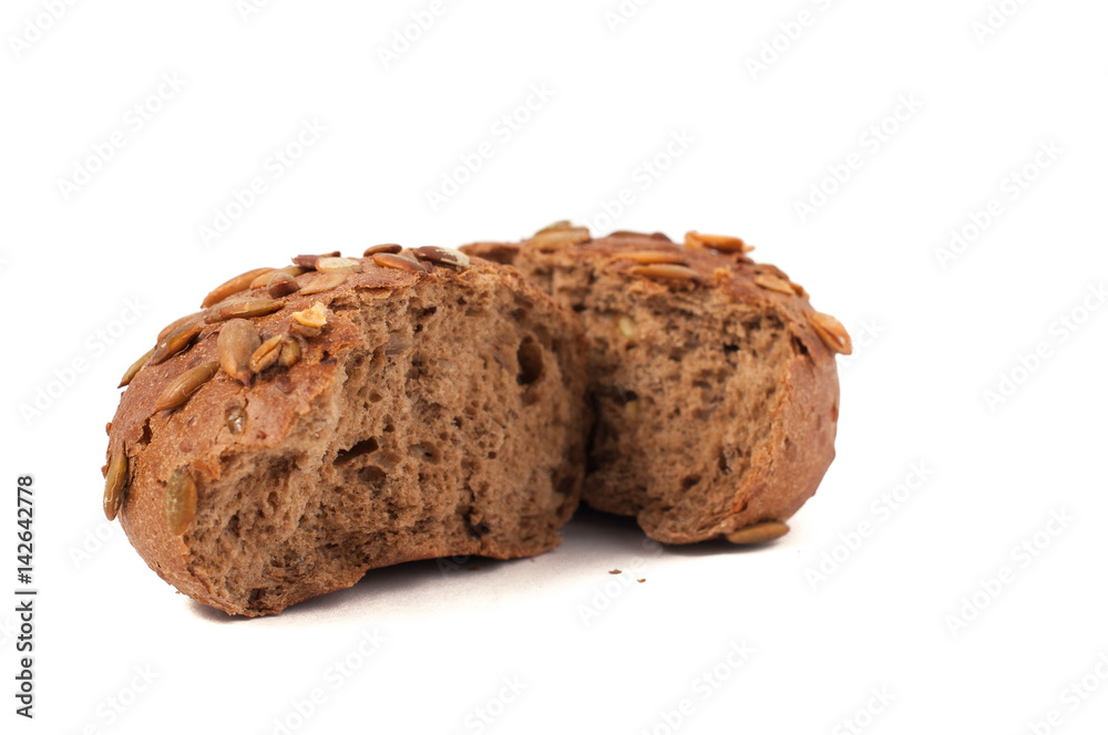 round a bun with pumpkin seeds wherein is isolated on a white background round a bun with pumpkin seeds wherein is isolated on a white background