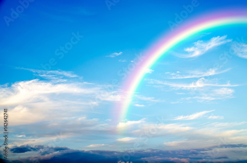 a blue sky rainbow background (clouds) . © slonme
