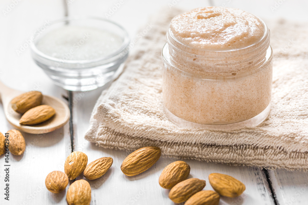 spa concept with almond nuts on wooden background spa concept with almond nuts on wooden background