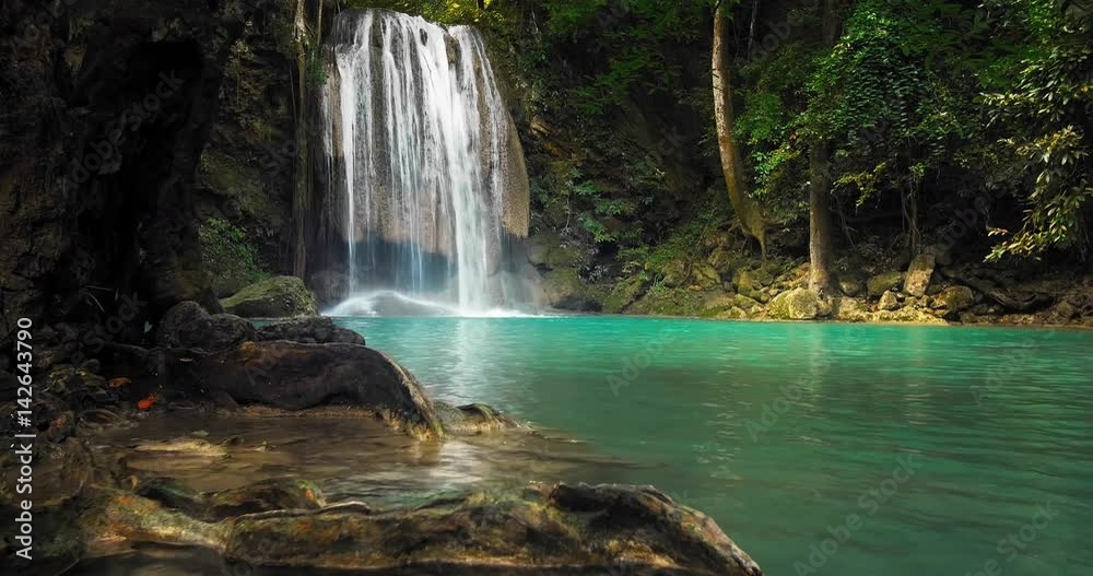 Beautiful waterfall in jungle forest. Clean emerald water flow of mountain river