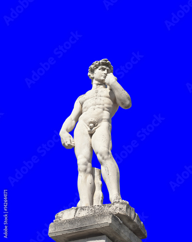 The statue of a greek athlete, isolated over a uniform blue background.
