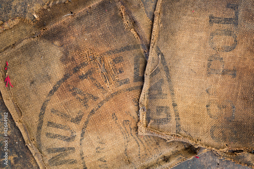 Old dirty hessian sack bag stamped used as upholstery material