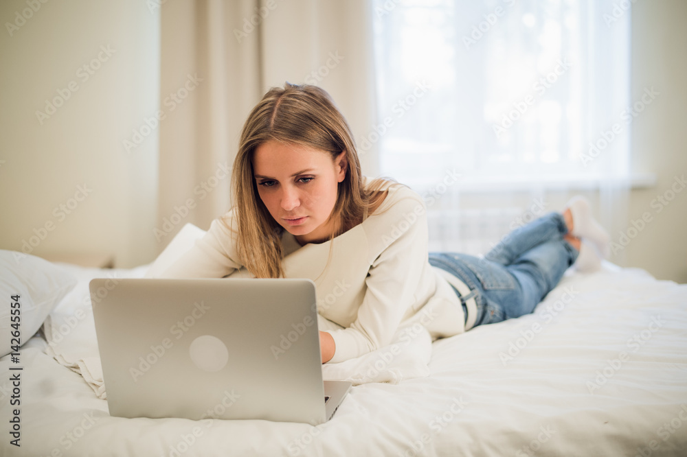 Portrait of a gorgoeus young blond woman shopping online using laptop Portrait of a gorgoeus young blond woman shopping online using laptop