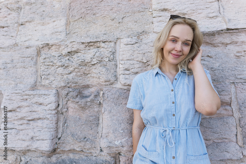 Photo of a beautiful blonde woman against the rustic church wall in France in Marseille Photo of a beautiful blonde woman against the rustic church wall in France in Marseille