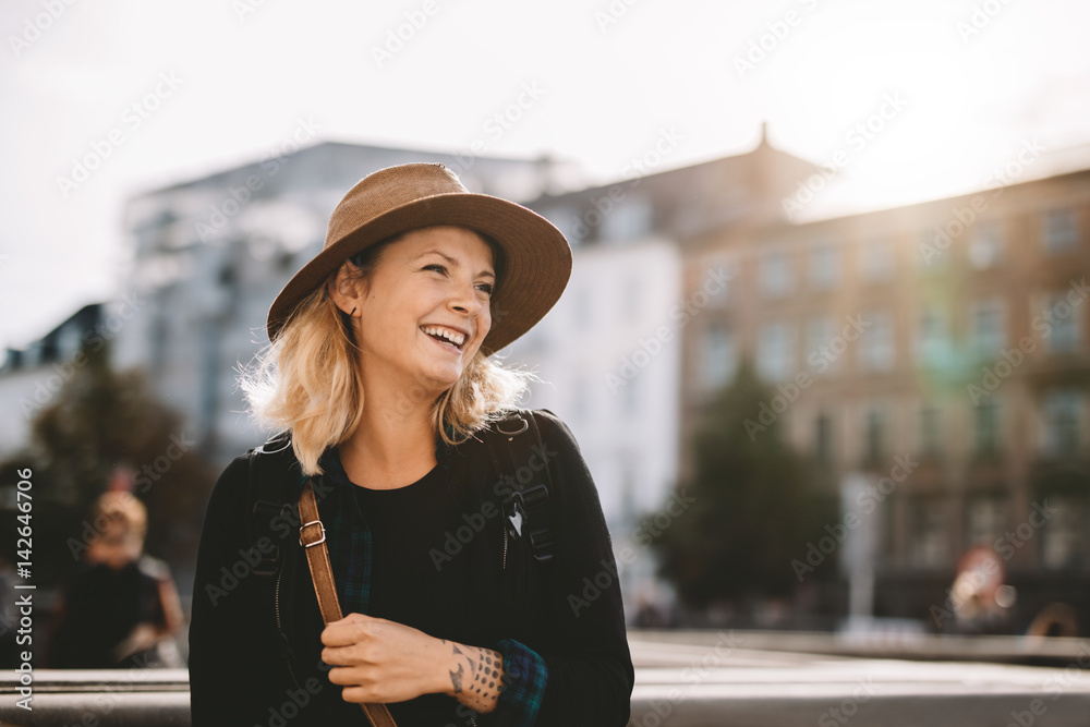 Smiling tourist woman wearing hat.