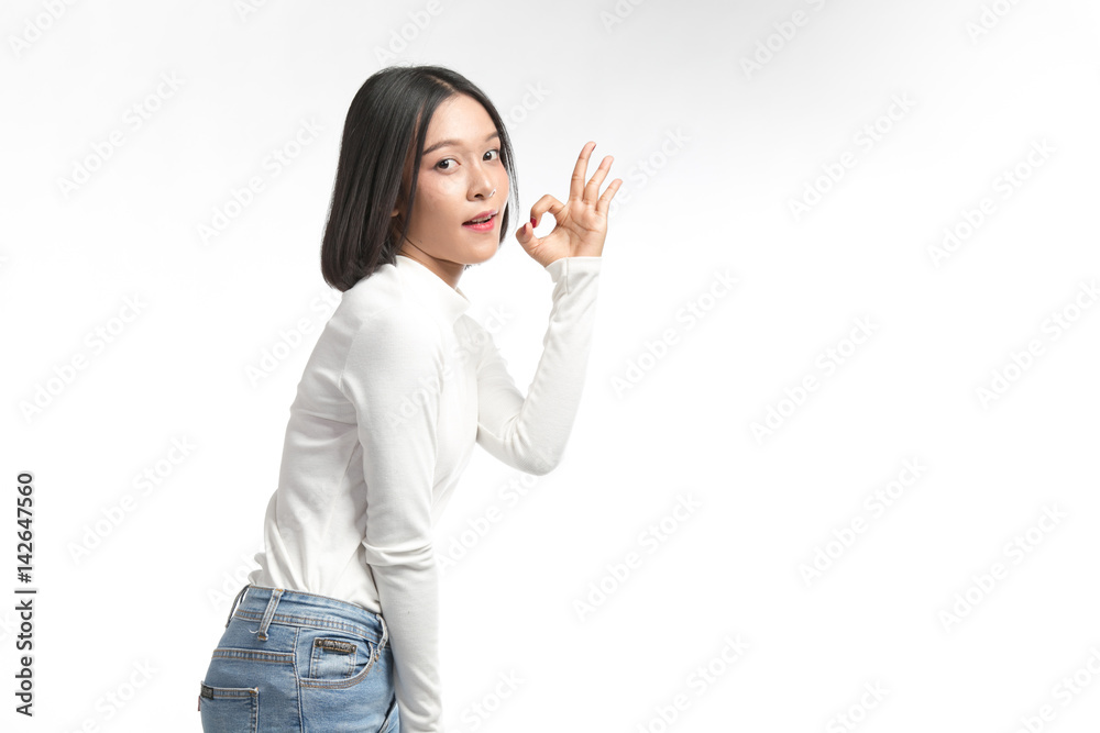 Beautiful asian girl making OK sign on white background Beautiful asian girl making OK sign on white background