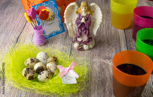 Colored Easter eggs table decoration with angel photo